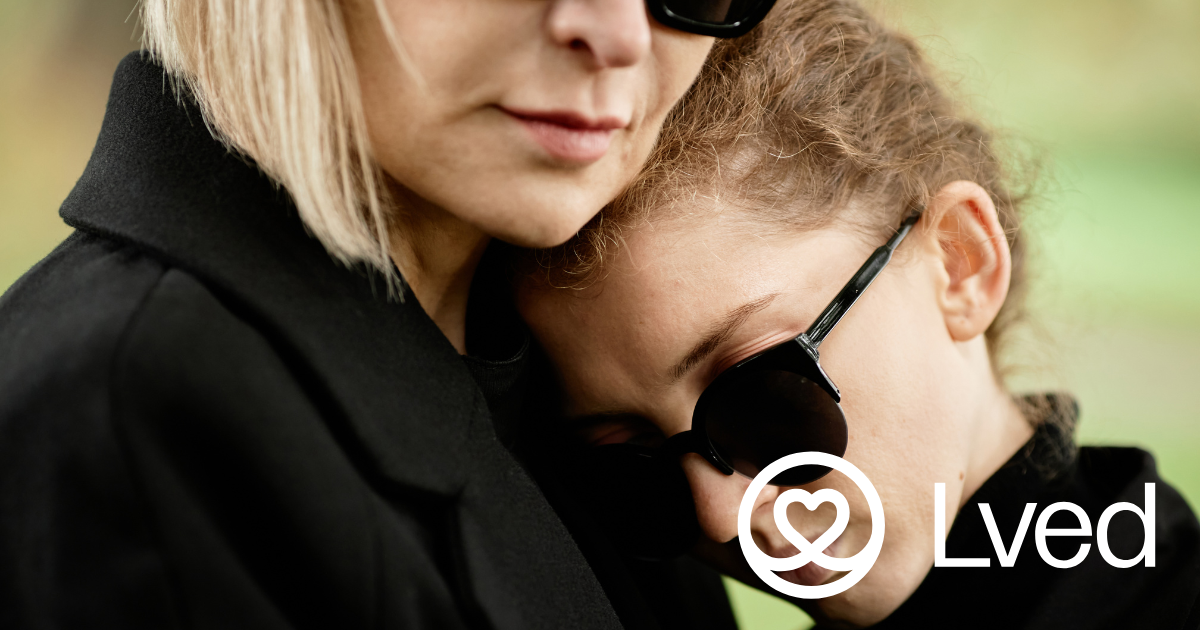 2 women in black with sunglasses, grieving