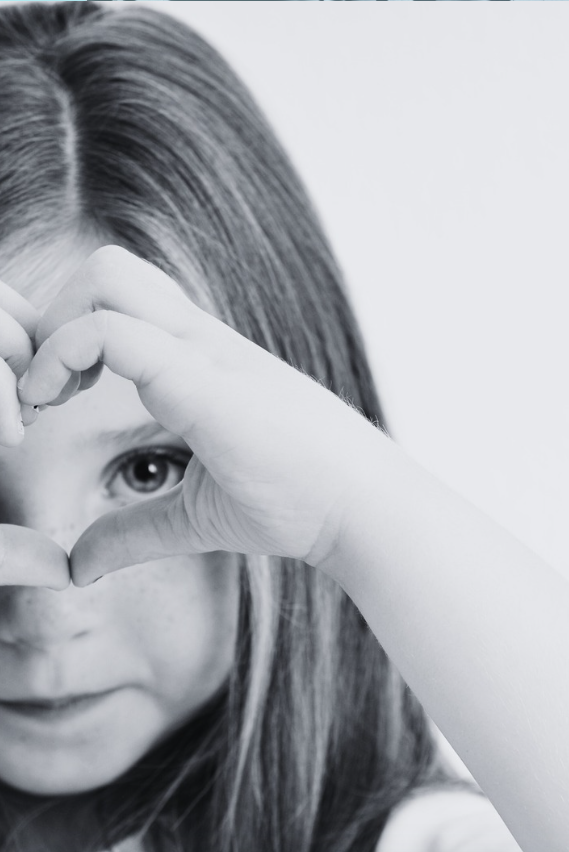 girl making heart shape